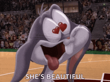 bugs bunny is on a basketball court with the words she 's beautiful behind him