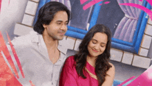 a man and a woman are standing next to each other and smiling
