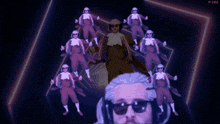 a man with sunglasses and a beard is surrounded by a bunch of people giving a thumbs up