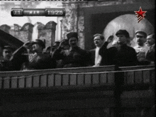 a black and white photo of a crowd of people with a sign that says ' 01 mah 19/15 '
