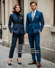 a man and a woman in blue suits are standing next to each other on a sidewalk