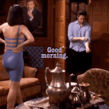 a woman in a blue dress is standing in front of a man in a blue shirt and the words good morning