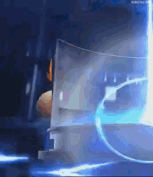a person is standing in a dark room with a blue light coming out of the window .