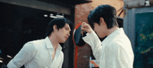 two men are looking at each other in a mirror