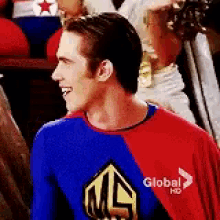 a man in a superhero costume is wearing a red and blue shirt that says global hd .