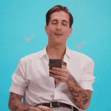 a man with his eyes closed is holding a cell phone