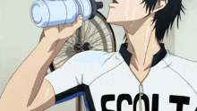 a man drinking from a bottle with the word colt on it