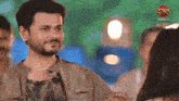 a man with a beard is standing next to a woman with a dangal tv logo behind him