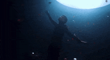 a person in a dark room with a light shining on them