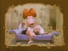 a cartoon character is sitting on a purple couch