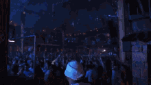 a crowd of people at a concert with a sign that says ' r ' on it