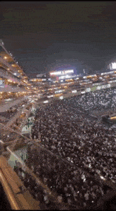 a large crowd of people are gathered in a stadium with a sign that says timberland