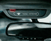 a rear view mirror with a trunk god machine sticker on it