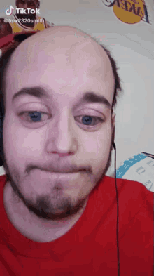 a man wearing headphones and a red shirt has a tiktok account