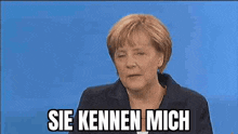 a woman with her eyes closed is making a funny face and saying `` sie kennen mich '' .