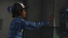 a girl in a baseball cap reaches out to a man in a video game and says " get out of m "