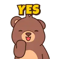 a brown teddy bear with a yes sign on its head