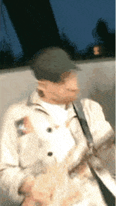 a blurry picture of a man wearing a hat and a jacket