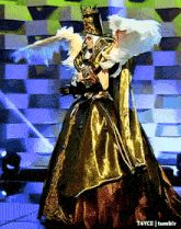 a woman in a costume with wings and a crown is standing on a stage with t4yce tumblr in the corner