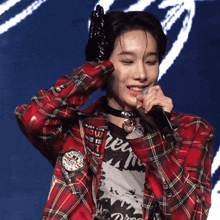 a woman wearing a plaid shirt and a black t-shirt that says dream