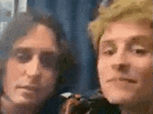 two men are standing next to each other and looking at the camera with their mouths open .