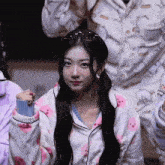 a girl wearing sunglasses and a pajama top with bears on it looks at the camera