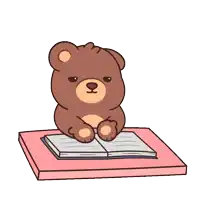 a brown teddy bear is sitting at a table with an open book