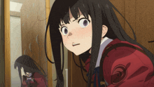 a girl with long black hair is looking at herself in the mirror