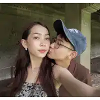 a man kisses a woman on the cheek while wearing a hat that says mexico