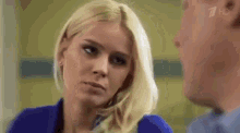 a man and a woman are looking at each other in a room .