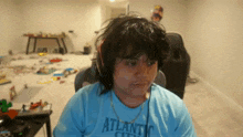 a man wearing headphones and a blue shirt with the word atlantic city on it .