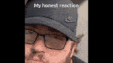 a man wearing glasses and a hat with the words my honest reaction above him