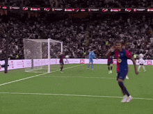a soccer game is being played in front of a crowd with a banner that says ' fc ' on it