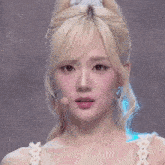 a woman with blonde hair is making a funny face