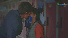 a man is kissing a woman on the cheek while holding a boston ball