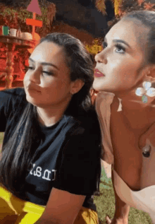 two women are posing for a picture and one has a black shirt that says ' i 'm a ' on it