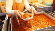 a person is pouring food into a pan that says made in animatica