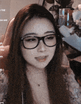 a woman wearing glasses sits in front of a screen that says ' s the cheese and ' on it