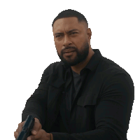 a man with a beard is holding a gun in his hands