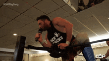 a man wearing a shirt that says icky rocks holds a microphone in his mouth