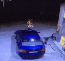 a blue car is being charged at a gas station with a cartoon character on top of it
