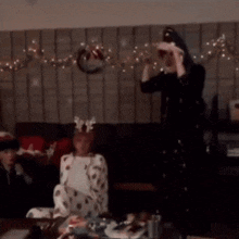 two men are standing next to each other in front of a christmas tree .