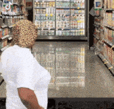 a woman wearing a leopard print hat is standing in a grocery store