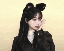 a girl wearing black cat ears and a leather jacket