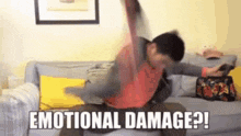 a man is sitting on a couch with his arms outstretched and the words `` emotional damage '' above him .