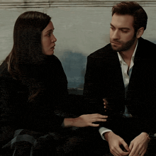 a man and a woman sitting next to each other