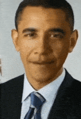 barack obama wearing a suit and tie smiles for the camera