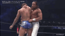 two wrestlers are wrestling in a ring that has a sign that says iwgp on it