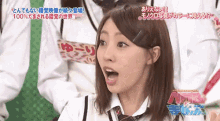 a woman with her mouth open and a sign that says nmb on the bottom