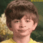 a close up of a child 's face with the name roy milton baker above him